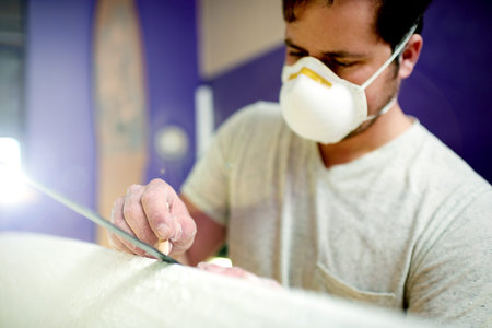 Man, face mask and chalk for carving on surfboard for measure design, shaping guide and repair work....