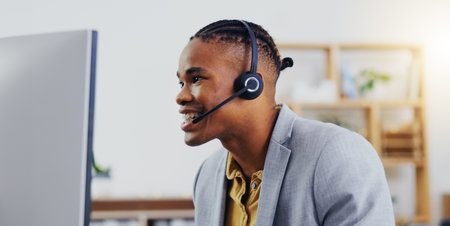 Customer service, laptop video call and happy black man networking on webinar, online conference or telemarketing. Communication microphone, callcenter consulting and office person on sales pitchの写真素材