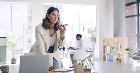 Creative, woman and phone for audio message with editor feedback, schedule update and contact source. Person, laptop and voice recording for article advice, project reminder and chat for publicationの写真素材