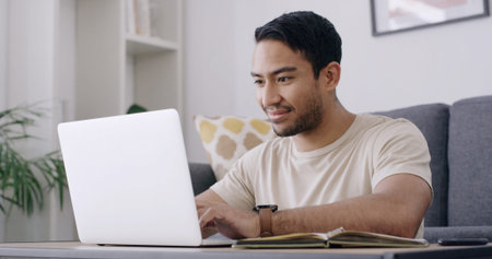 Man, student and laptop with typing in home, smile and review project for online course in lounge....