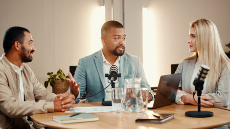 Podcast, people and talk for interview in studio, business show and content creation. Group, podcaster and microphone for recording audio with panel, broadcast or live stream for entrepreneur adviceの写真素材