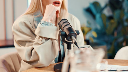 Podcast, talking or woman in studio with microphone, discussion or personal story in streaming show. Broadcast, digital or influencer in booth with tech, announcement or sharing idea in chat.の写真素材