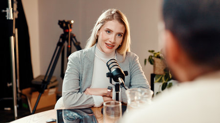 Podcast, interview or people in studio with microphone, discussion or personal story in streaming show. Broadcast, digital or influencer in booth with equipment, announcement or sharing idea in chat.の写真素材