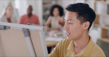 Employee, talking and man with board, presentation and strategy for brainstorming. Boardroom, coaching and marketing manager with ideas for business growth, meeting and planningの写真素材