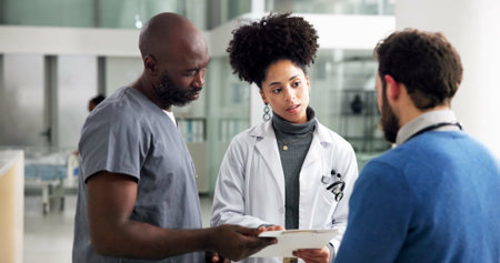 Healthcare, doctors and people with document in hallway, patient care file and discussion of...