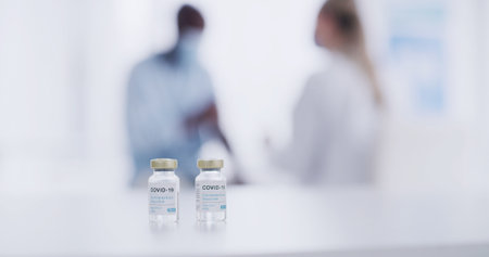 Vaccine, vials and medicine for covid 19 in hospital, bottles and immunization for patient and space. Pharmaceutical, healthcare and booster for disease prevention, people and treatment for wellnessの写真素材