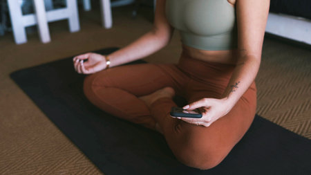 Woman, hands or meditation with phone for online class, inner peace or spiritual healing in home. Female person, yogi and zen app with mobile smartphone for awareness, health and wellness in houseの写真素材