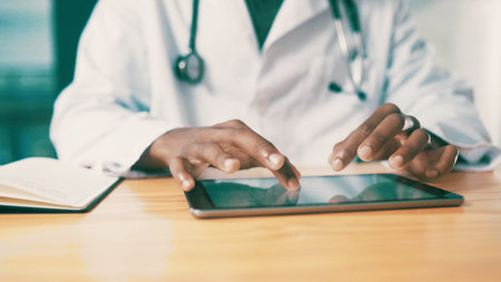 Doctor, hands and tablet with screen for medical research, telehealth or online app in hospital....