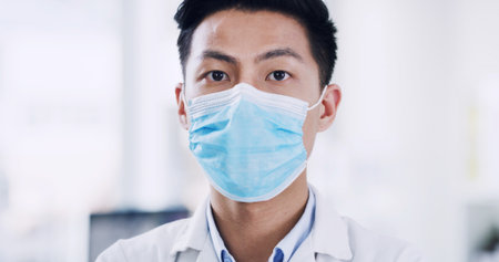 Face mask, portrait and science with Asian man in laboratory for medicine development or research. Engineering, pharmaceuticals and ppe with doctor or medical scientist at work for healthcareの写真素材