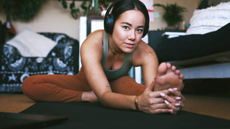 Laptop, headphones and woman with stretching on mat for yoga routine, online class and flexibility....