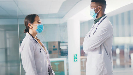 Medical, student doctors and speaking for healthcare collaboration, knowledge sharing or advice. Case discussion, internship or people with masks for teamwork, planning clinical diagnosis and helpingの写真素材