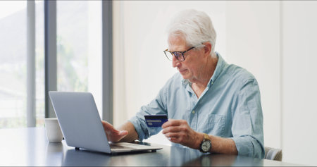 Credit card, laptop and businessman in office with online shopping, ecommerce and purchase. Computer, bank account and mature male financial manager with investment on website for finance growth.の写真素材