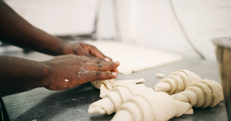 Bakery, pastry chef and hands in commercial kitchen with dough, croissant and small business. Baker, order and quality control for catering, restaurant industry and production for breakfast or snackの写真素材