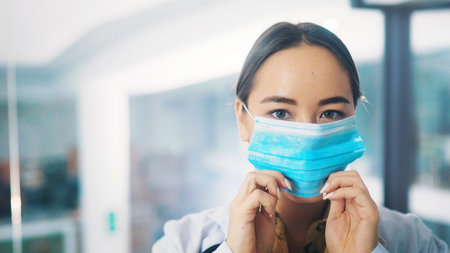 Portrait, doctor or woman in hospital with face mask for healthcare consultation or protection from Covid. Space, medical professional or PPE for safety compliance, wellness or spread of coronavirus.の写真素材