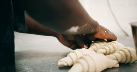 Bakery, pastry chef and hands in commercial kitchen with croissant, dough and small business. Baker, order and quality control for catering, restaurant industry and production for breakfast or snackの写真素材
