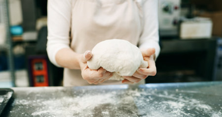 Restaurant, dough and hands of baker in kitchen for bread, cooking and mixing flour. Bakery, ingredient and kneading with person baking in cafe for wheat pizza base, coffee shop and culinary processの写真素材