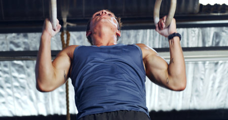 Athlete, man and exercise with gymnastics rings for fitness, pull up and training for body strength....