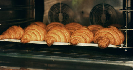 Bakery, oven and croissants in commercial kitchen with food, cooking and small business. Patisserie, order and quality control for catering, restaurant industry and production for breakfast or snackの写真素材