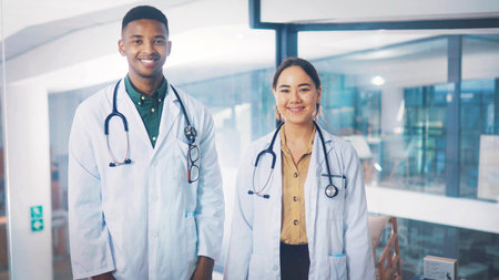 Portrait, doctors and happy people in office for medical services, healthcare or cardiology career. Professional, cardiac health or specialist with smile in hospital, wellness or heart care physicianの写真素材