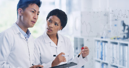 Team, tablet and glass wall with people in lab for blood sample, chemistry formula and enzyme reaction. Medical research, digital report and brainstorming equation with scientists in clinic studyの写真素材
