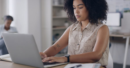 Creative agency, typing and woman in office, laptop and check facts for article. People, deadline and journalist with pc, company newsletter and magazine editor with internet and research for reportの写真素材