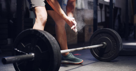Man, fitness or hands with chalk or barbell for workout preparation, muscle gain or exercise in gym. Active, male person or getting ready with powder for weightlifting or training in health clubの写真素材