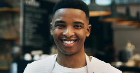 Portrait, bakery and black man with smile, small business and confidence with food industry. African person, baker and entrepreneur in kitchen, happiness and pastry chef with pride and hospitalityの写真素材