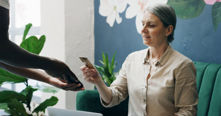 Cafe, credit card and payment service with POS machine for customer order, beverage or purchase. Woman, barista and waiter with tap to pay, mobile smartphone and NFC sale for checkout in coffee shopの写真素材