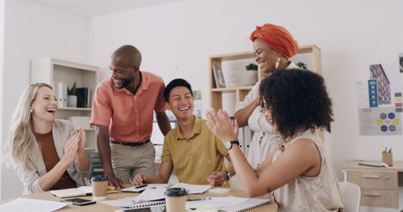People, applause and success with team, graphic design and support for goal achievement at startup. Group, men and women with celebration, motivation or smile for project funding at creative agencyの写真素材