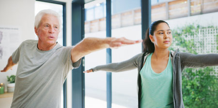 Old man, stretching and physical therapy with healthcare worker for fitness, muscle recovery and wellness. Yoga, senior person and physiotherapy with warrior pose, rehabilitation support and care.の写真素材