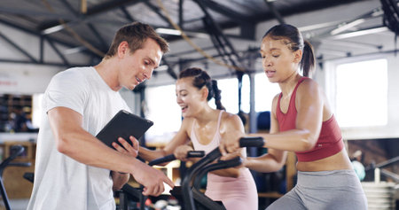 Man, tablet and talking to people in spin class for fitness record, schedule session and progress....