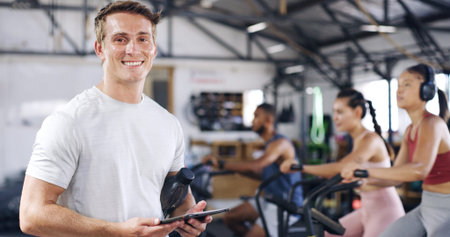 Portrait, man and tablet with people in spin class for fitness results, schedule session and...