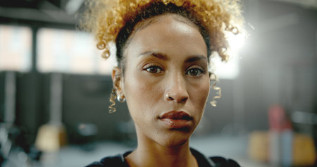Portrait, African woman and athlete at gym for fitness pride, membership and exercise. Serious, female person and confident for training, sports assistance and attitude for wellness benefitsの写真素材