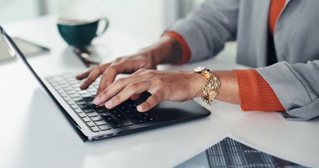 Hands, typing and laptop at startup, report and project management in office at media company. Person, writer or editor with pc, article or review story for publishing in workplace at creative agencyの写真素材