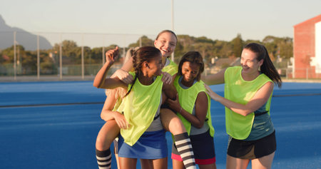 Outdoor, sports game and women with celebration, excited and cheering with competition. Champion, happy players or team with solidarity, winning and victory with achievement, hockey group and successの写真素材