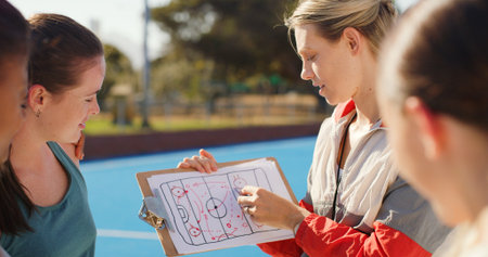 Coach, strategy and clipboard with team outdoor for hockey match, tournament or competition. Sports manager, people or pointing to game plan on turf for tactical feedback, formation and instructions.の写真素材