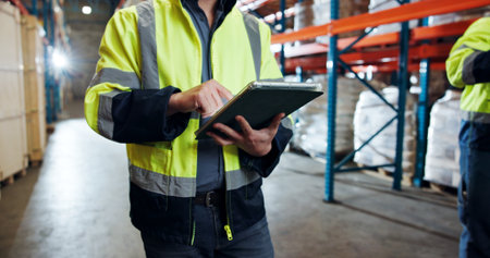 Tablet, logistics worker and hands in warehouse for distribution, supply chain or check stock. Digital technology, shipping and person with inventory management for cargo, storage or quality controlの写真素材