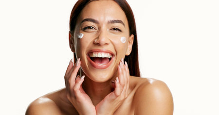 Woman, skincare and happy with cream in studio, pride and confidence with mockup space on white background. Person, smile and portrait with lotion, moisturizer and product for beauty in Colombiaの写真素材