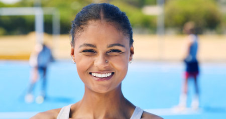 Hockey, happy and portrait of woman outdoor with smile for training, practice and exercise for competition. Sports team, fitness and person with confidence for match, game and tournament for hobbyの写真素材