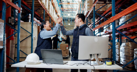 Logistics, computer or team with high five in warehouse for shipping target, sales record or good...
