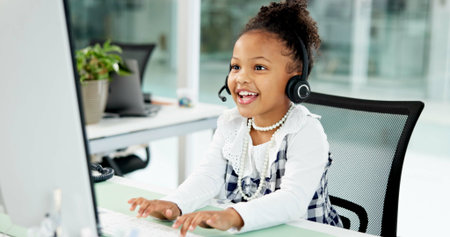 Costume, call center or girl in office with headset, business cosplay or consultant in customer service. Telecom, happiness or child in agency with desktop, dress up or support in client assistance.の写真素材