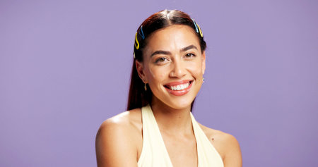 Portrait, happy and woman with makeup in studio for beauty, natural shine and makeover. Mockup space, gen z and person with confident with cosmetology, facial glow and aesthetic on purple backgroundの写真素材