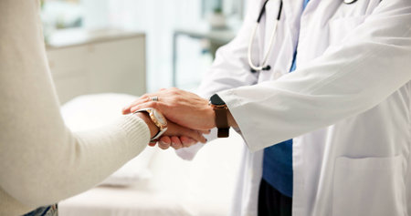 Hospital, doctor and comfort for patient, hands and healthcare support for diagnosis or medical care. Appointment, people and empathy for illness, trust and reassurance for help and healing in clinicの写真素材