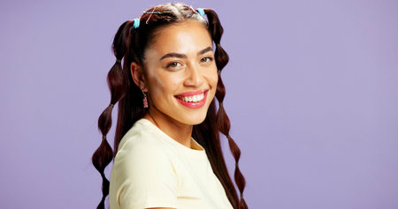 Beauty, portrait and smile of woman in studio for gen z cosmetics, dermatology or skincare. Aesthetic, excited and hairstyle with happy model person isolated on purple background for satisfactionの写真素材