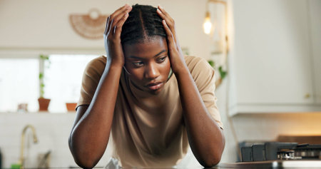 Thinking, headache and woman with stress in kitchen for burnout, overworked and household pressure....