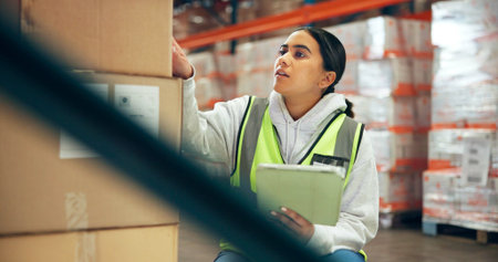 Woman, logistics and box with tablet in warehouse for supply chain, shipping info and label update....