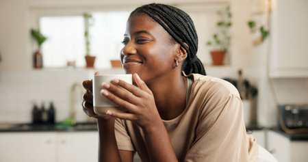 Coffee, happy and black woman in home on morning on weekend for relax, calm or peace in kitchen....