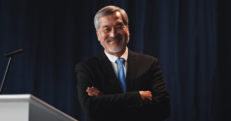 Mature man, portrait and confident politician at podium for election campaign event, pride or happy....