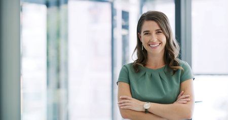 Happy woman, portrait or corporate management with confidence in office for career development. Female person, employee or manager with space or arms crossed for job opportunity or pride in workplaceの写真素材