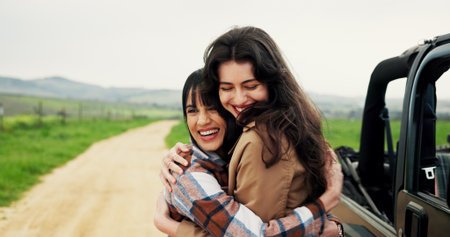 Travel, hug or women with smile, vehicle or bonding together with road trip, adventure or countryside. Outdoor, people or friends with happiness, embrace or journey with holiday, relax or destinationの写真素材